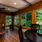 remodeled four seasons room with wood paneled walls and timbers in ceiling