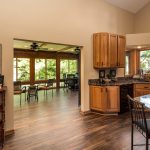 remodeled flooring in kitchen leading into four seasons room