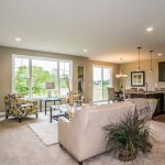 Living room, kitchen, and dining space inside new home in St. Johns