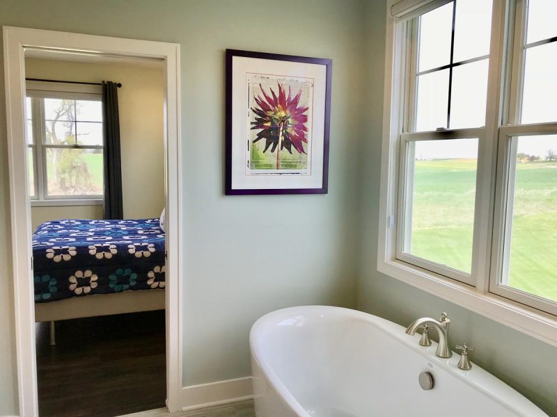 A soaking tub with peaceful view out an andersen window