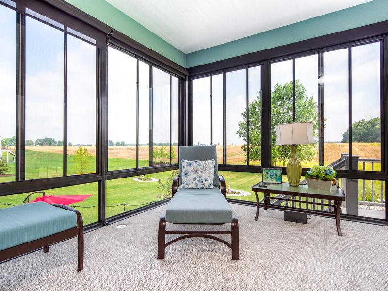 Four seasons room with windows looking out into farmland