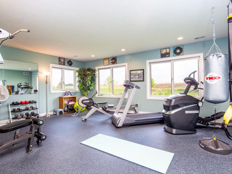 Basement workout room with big windows and custom soft flooring