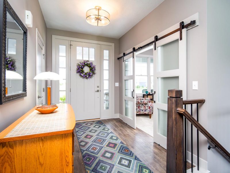 Foyer with 8 foot high front door and barn doors for study
