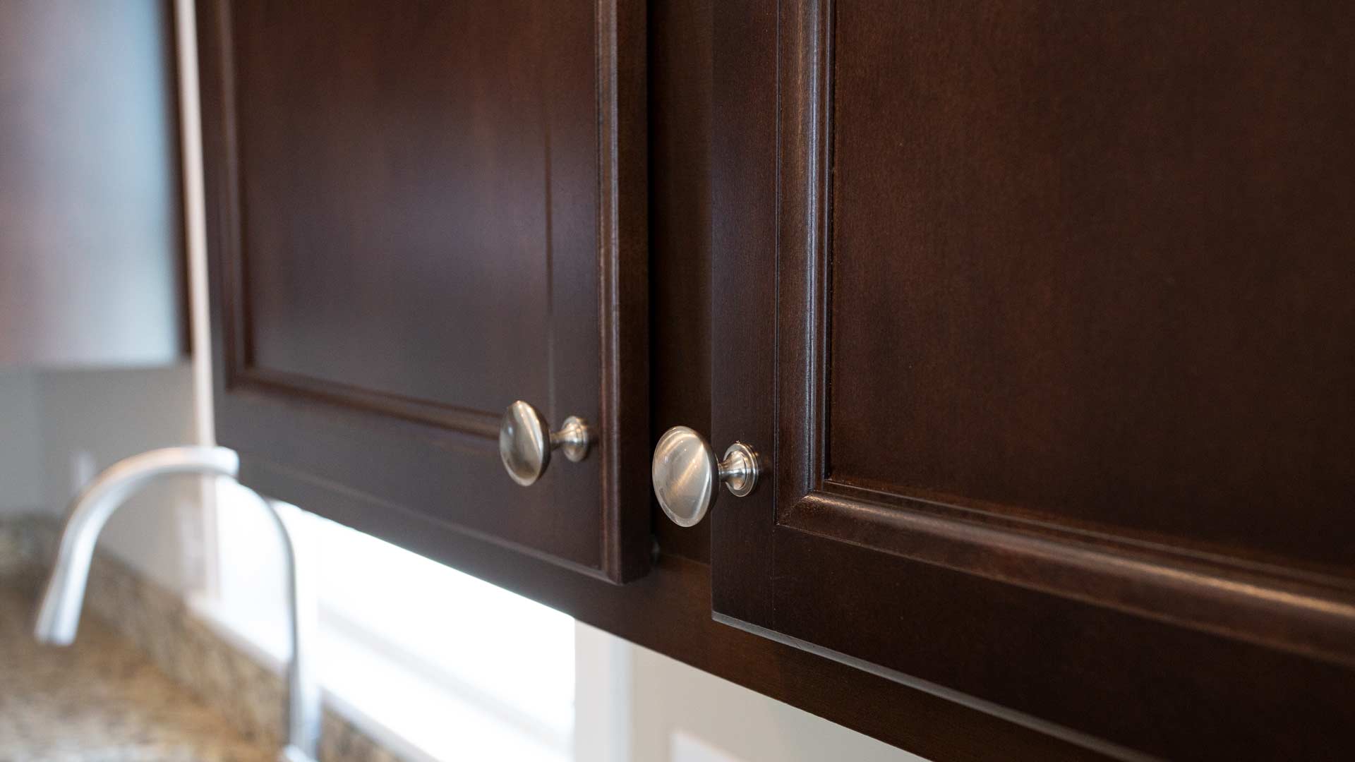 Detail shot of brown cabinets with satin pulls