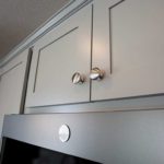 Detail shot of grey cabinet with satin knobs