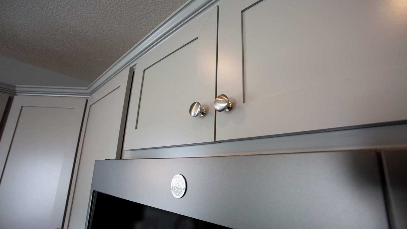 Detail shot of grey cabinet with satin knobs