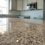 Granite countertop with flecks of white, grey and black on kitchen island